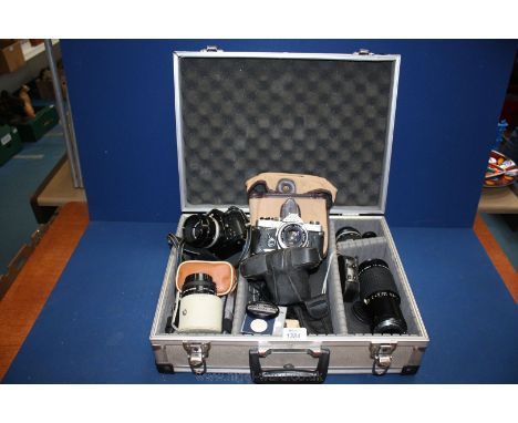 An Aluminium camera case and contents including Nikon F-501 AF camera with 55mm Nippon lens, an Olympus OM 10 camera with a 5