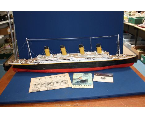 A model of the Titanic, 43'' long plus other associated memorabilia  including a plaque and newspaper, etc.