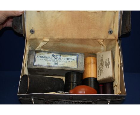 A vintage Military canvas over metal First Aid Case containing several vintage medical items including medicine measures in w