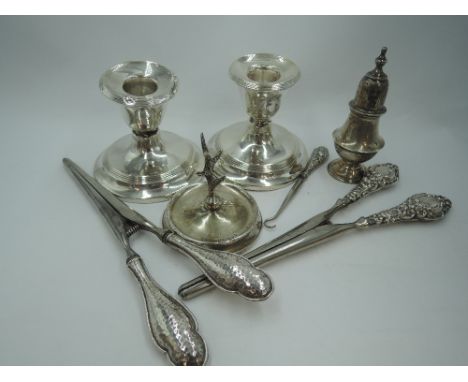 A selection of HM silver including two pairs of glove stretchers having moulded handles, a small ring tree, pepperette and pa