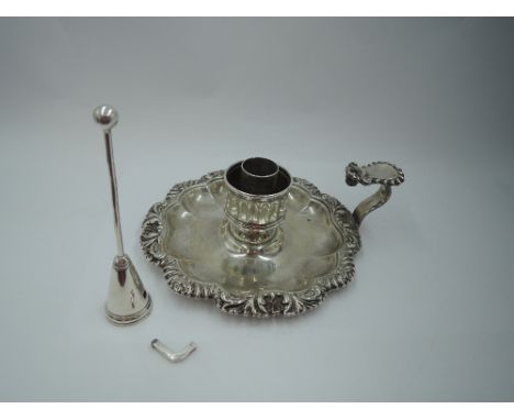 A Georgian silver chamber stick (missing sconce) having facetted saucer with shaped gadrooned rim and thumb rest, candle hold