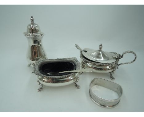 A silver three piece cruet set of traditional form having gadrooned rim and paw feet, Birmingham 1962, William Suckling Ltd, 