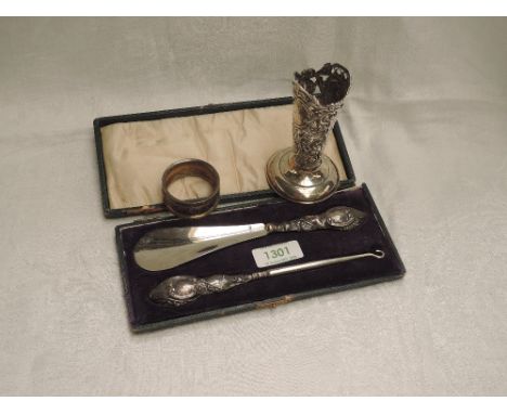 A small selection of HM silver including a cased silver handled button hook and shoe horn, napkin ring and Victorian bud vase