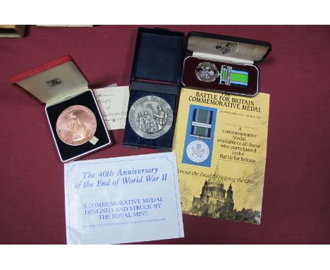 A Royal Mint Bronze 40th Anniversary End of WWII Medal, case, a Battle of Britain Commemorative Medal, cased, and Airborne Fo