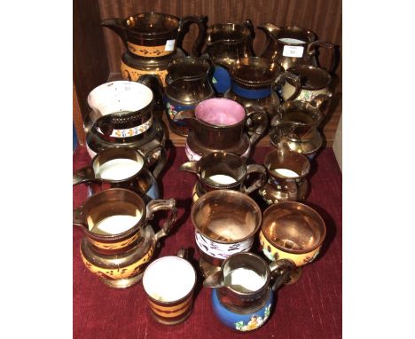 A collection of thirteen mainly copper lustre ceramic jugs, 18cm - 9cm and other lustre ware.