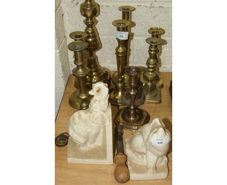 Various brass candlesticks, a ceramic elephant bookend and other items.