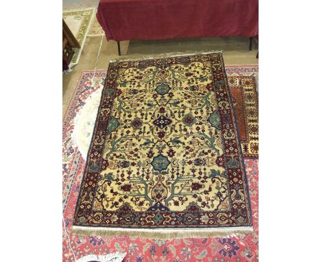 A modern Oriental rug with geometric design on ivory and burgundy field, 220 x 140cm.