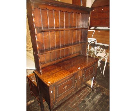 1930's Oak dresser having a boarded shelf back above two doors on barley twist supports 