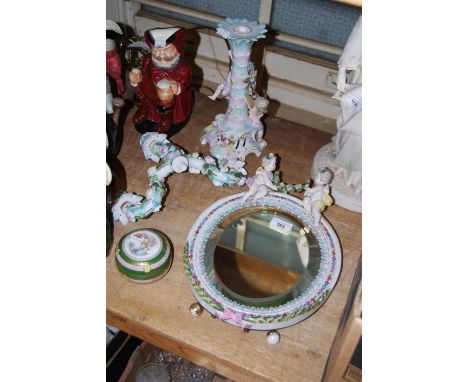 Late 19th Century Continental porcelain oval wall / table mirror with cherub surmount, 14ins high approximately, together wit