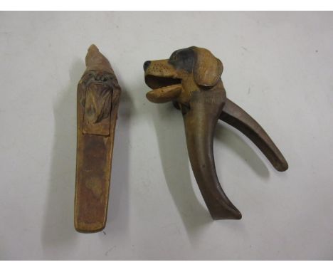 Carved wooden nutcracker in the form of a dog's head and another in the form of a bearded gentleman 