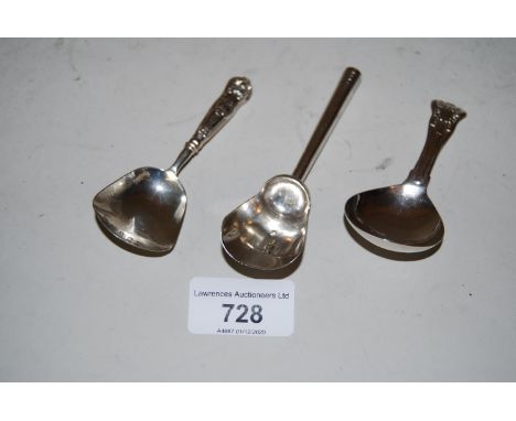 Two 19th Century shovel form silver tea caddy spoons together with a 19th Century silver Shell and Fiddle pattern caddy spoon