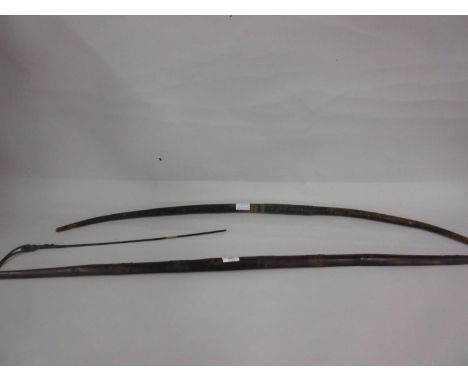 Wooden shafted leather bound Woomera stick and a wooden bow with leather wire twist grip 