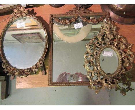 Small rectangular gilt brass hanging mirror with torch surmount, together with a small cast brass mirror and small compositio