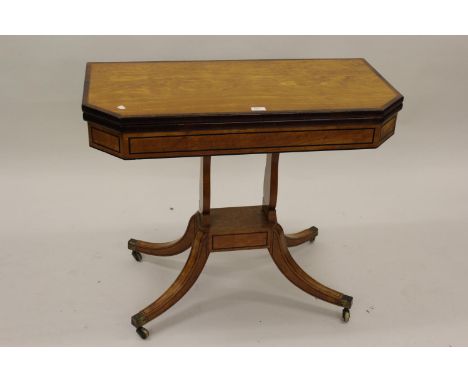 Regency satinwood rosewood crossbanded and line inlaid fold-over card table, the baize lined top above twin shaped supports a