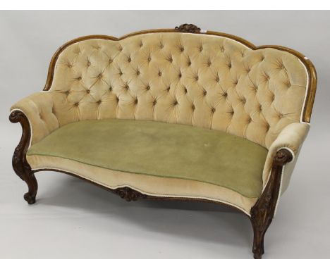 Victorian oak drawing room sofa, the shaped button upholstered back above an overstuffed seat and carved scroll shaped front 