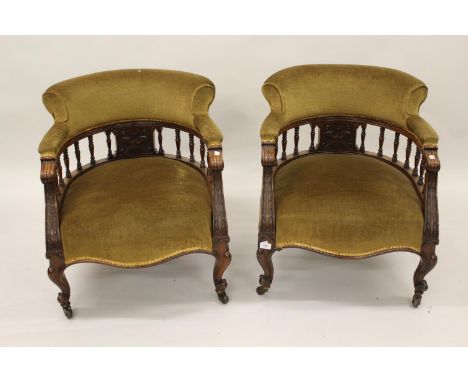 Pair of 19th Century walnut tub shaped drawing room chairs having green dralon upholstery and spindle backs with carved decor
