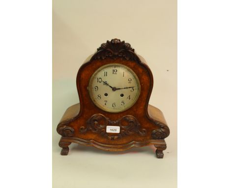 20th Century continental burr walnut mantel clock with a silvered dial, arabic numerals and two train movement, striking on a