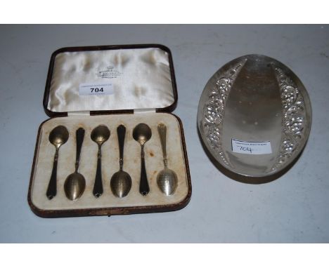 Cased set of six silver coffee spoons with engine turned decoration, together with a Continental white metal oval floral embo