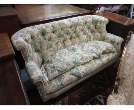 Victorian button upholstered two seat sofa, the rolled back above an overstuffed seat on turned tapering supports with brass 