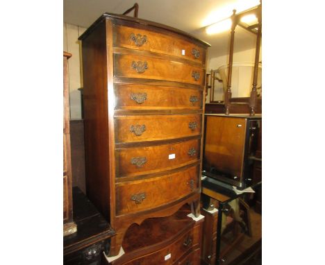 Early to mid 20th Century walnut and crossbanded narrow bow front chest of six graduated drawers with brass handles and splay