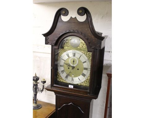 George III oak longcase clock, the broken arch hood above shaped panel door and plinth base, the gilt and silvered dial with 