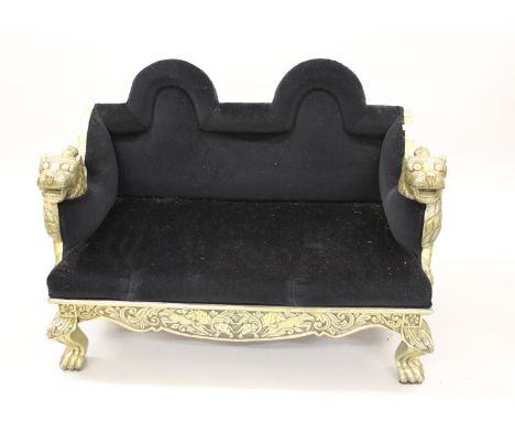 Unusual Indian black velvet upholstered two seat sofa, the relief decorated back decorated with flowers and lion masks, the s