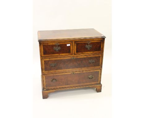 Late 18th / early 19th Century burr walnut veneered and crossbanded chest of two short over two long drawers with brass swan 