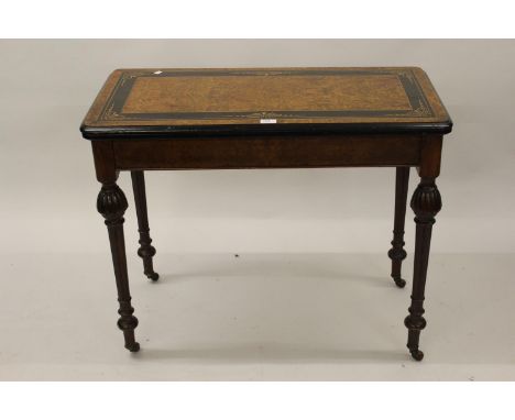 Victorian amboyna ebonised and inlaid rectangular foldover card table on baluster turned supports, 36ins wide 