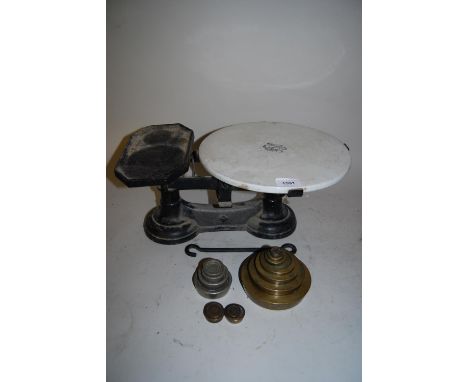 Pair of Victorian cast iron and ceramic kitchen scales by Avery together with a quantity of weights (at fault) 