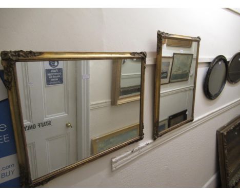 Pair of rectangular gilt moulded wall mirrors together with another gilt wall mirror with segmented frame 