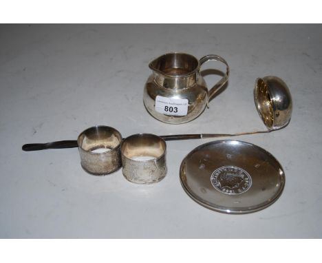 Modern silver jug of plain design, silver trinket dish inset with a coin, two silver napkin rings and a toddy ladle with twis