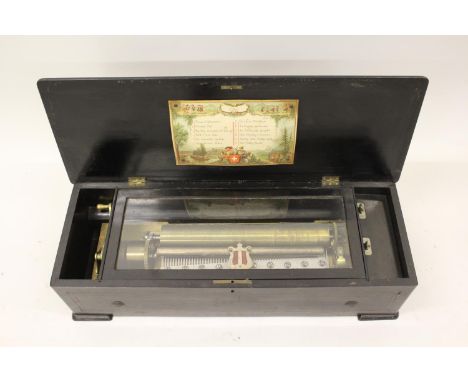 19th Century Swiss rosewood marquetry inlaid and ebonised musical box, the 13in cylinder playing twelve airs, 26.5ins wide, 7