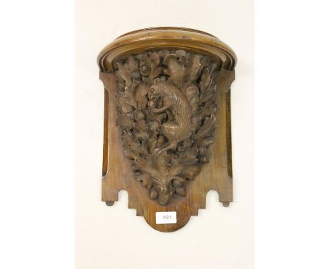 19th Century wall bracket carved with acorns, oak leaves and a squirrel, 14ins high (at fault) 