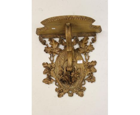 Large late 19th / early 20th Century Black Forest light wood wall bracket, carved with acorns, acorn leaves and flowers, 17.5