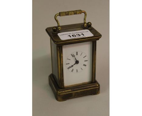 Small brass cased carriage clock with enamel dial and Roman numerals 