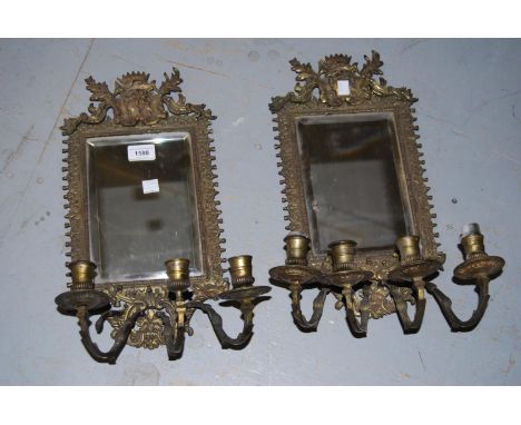 Pair of brass mirror backed candle brackets ( minus one arm)Overall height about 18ins. One candle bracket is missing. 