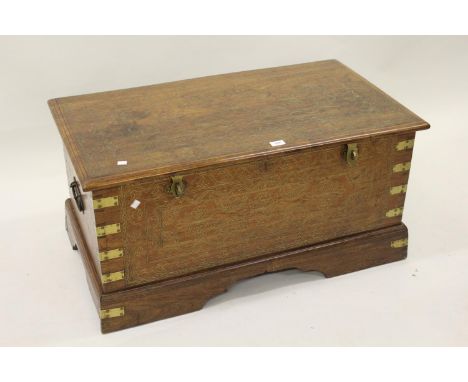 20th Century Eastern hardwood and brass inlaid trunk, the hinged lid enclosing a fitted interior secured by brass catches and
