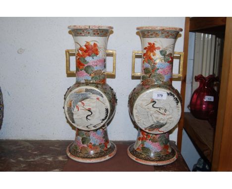 Pair of large two handled Japanese vases having enamel, floral and bird decoration on flared bases (at fault), 16ins high 