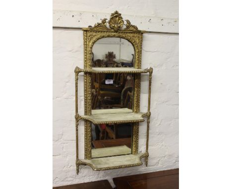 19th Century gilded composition three shelf wall bracket with shell surmount above a mirrored back, 33ins high together with 