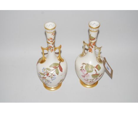 Pair of Worcester ivory ground vases with all-over floral decoration, gilt side handles, 9.75ins high (one at fault) 