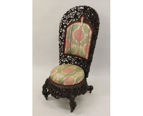 Late 19th Century Burmese heavily carved and pierced high back chair of foliate carved design with padded back, circular over