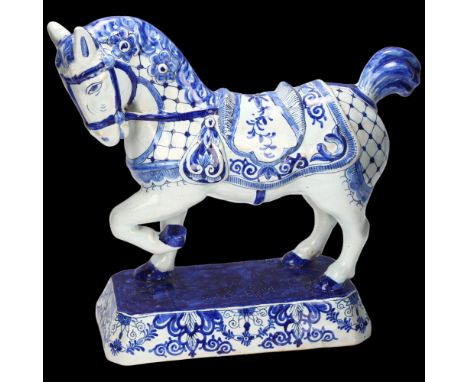 Delft faience blue and white pottery saddled horse, length 22cm, base length 17cm General light glaze crazing, possibly profe