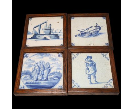 4 Delft blue and white pottery tiles, in oak frames, frame dimensions 15cm x 15cm Tile with 3 figures has chipped top right-h