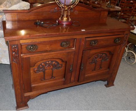 An Arts &amp; Crafts oak sideboard, carved with stylised flower and brass handles, 152cm by 54cm by 95cm  .   116 cms to top 