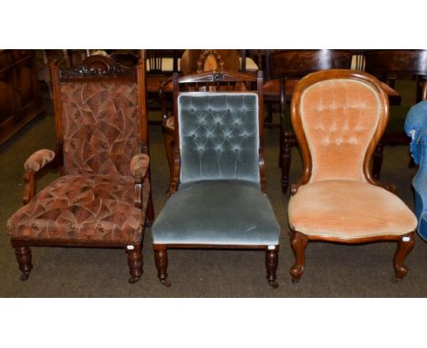 An Edwardian mahogany framed open armchair, an Edwardian mahogany nursing chair, and a Victorian button backed nursing chair 