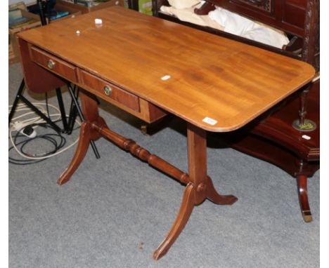 A reproduction mahogany coffee table, the shaped top above a shelf, moving on castors, 120cm by 71cm by 43cm, together with a