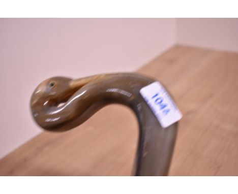 An unusual walking stick with a carved birds head handle