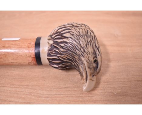 A walking stick with a cast resin head of an Eagle 142cm long