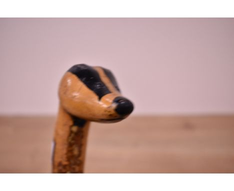 A Hazel walking stick with the top carved into a badgers head measuring 96cm long