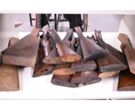 A shelf of old gunstocks and a few locks
